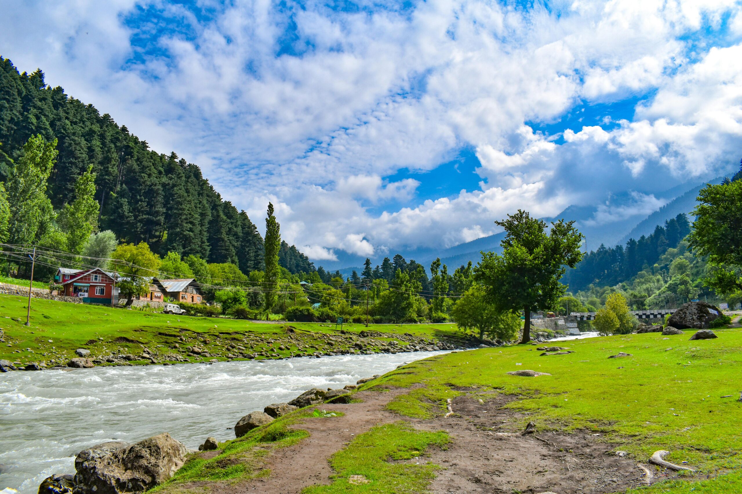 Beautiful river scene in Indonesia with lush greenery and a vibrant blue sky.