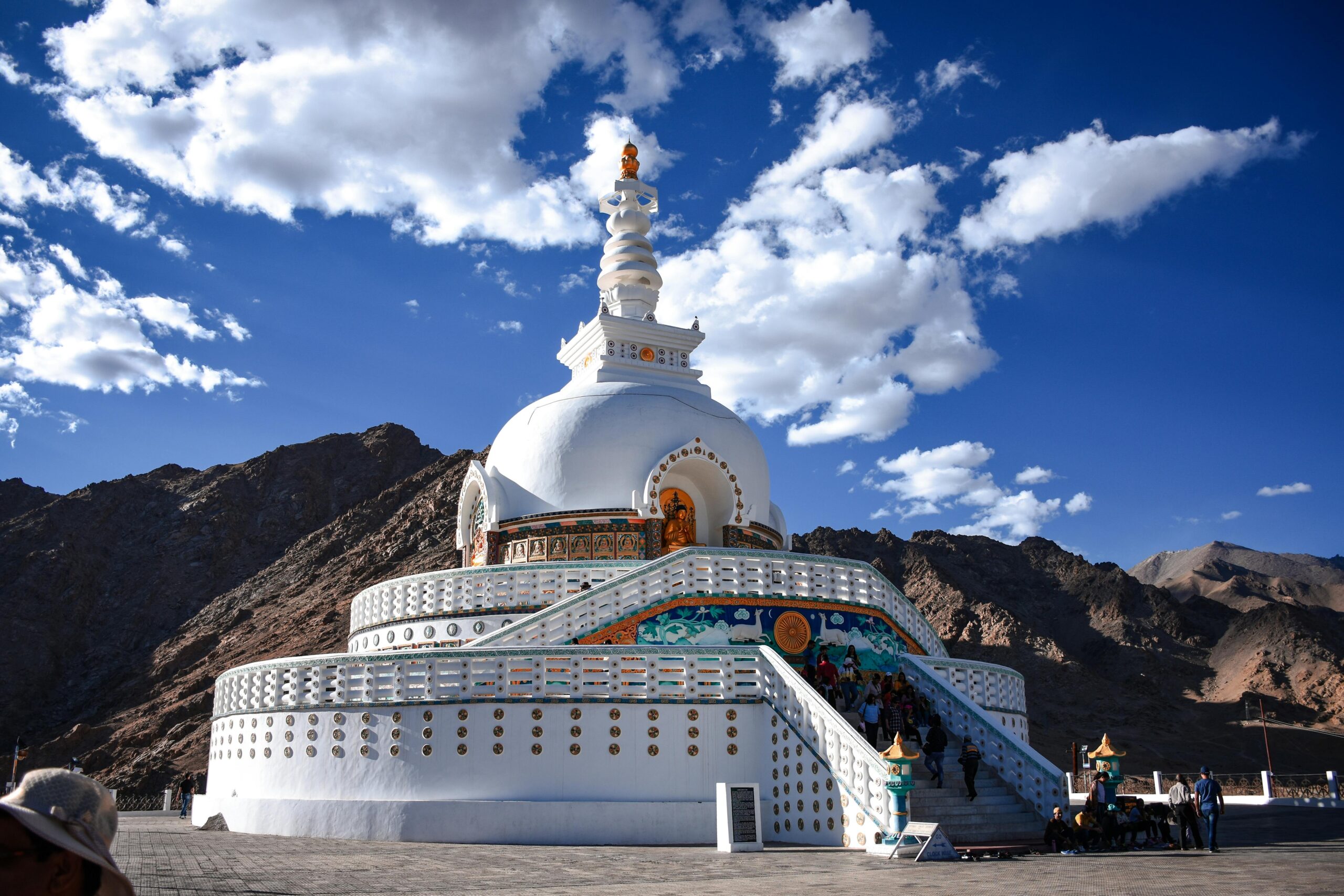 Capture of the Shanti Stupa against a stunning mountainous landscape in Leh under a clear blue sky.